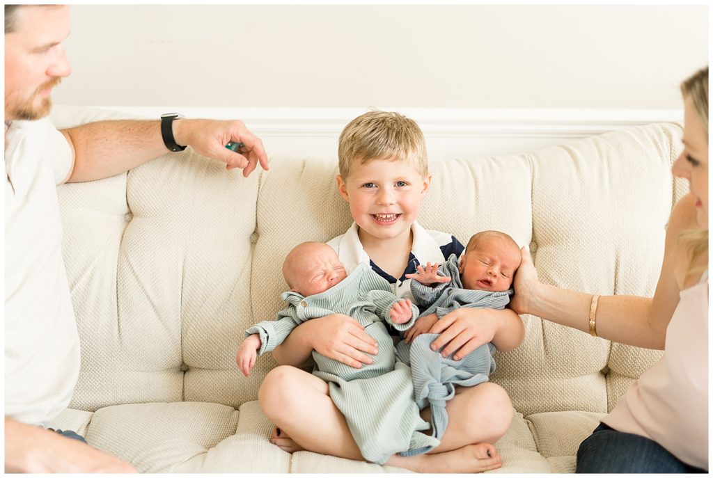 big brother so happy to be holding twin brothers