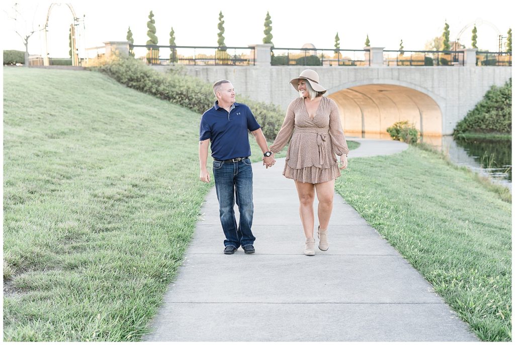 Husband and Wife walking down path at Coxhall Gardens in Carmel, Indiana